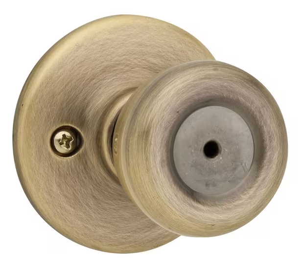 Kwikset Tylo Antique Brass Bed/Bath Door Knob Featuring Microban Antimicrobial Technology with Lock